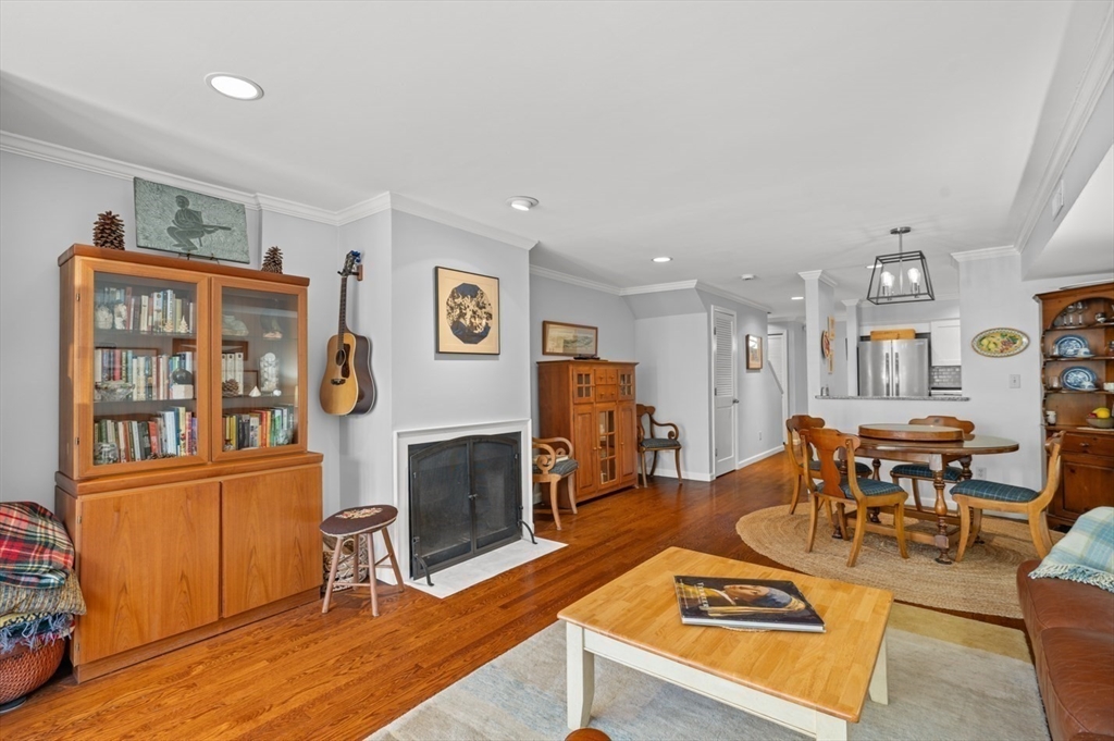 27 R West Street, Unit 4 Beverly, MA 01915 - Photo 2 of 27 a living room with furniture a flat screen tv and a fireplace