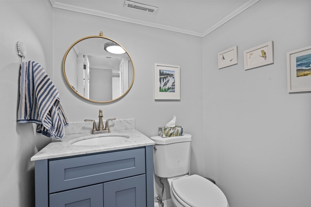 27 R West Street, Unit 4 Beverly, MA 01915 - Photo 5 of 27 a bathroom with a toilet a sink and mirror