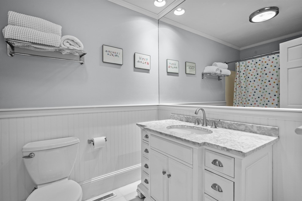 27 R West Street, Unit 4 Beverly, MA 01915 - Photo 6 of 27 a bathroom with a granite countertop sink mirror vanity and toilet