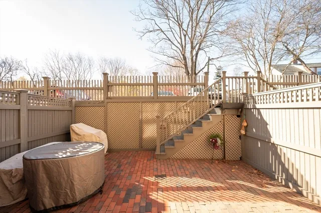 a view of a balcony with wooden fence and floor