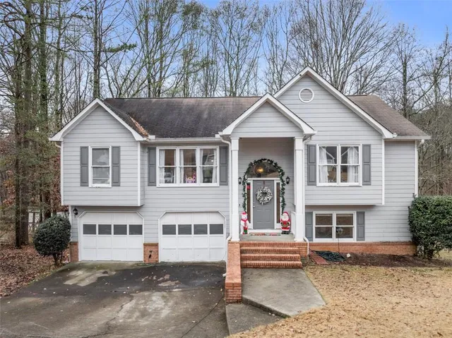 a front view of a house with a garden