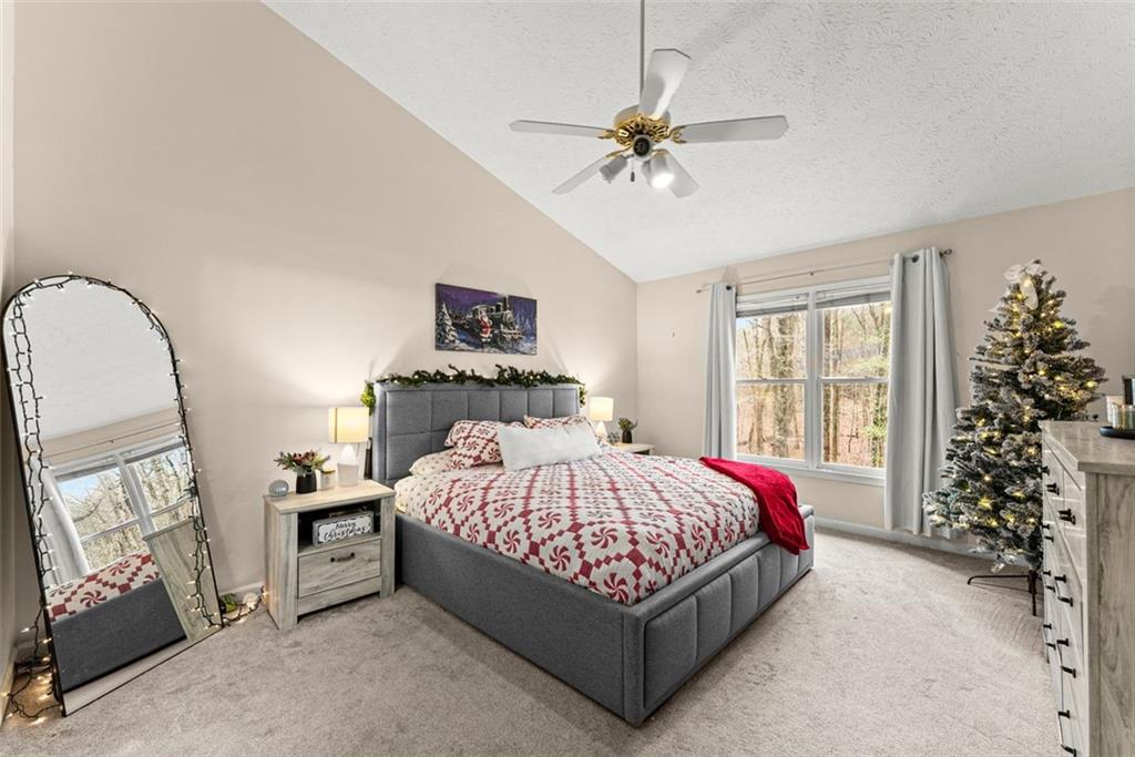 2980 Phillips Bend Crossing Northeast Buford, GA 30519 - Photo 16 of 45 a bedroom with a bed a chandelier and dresser