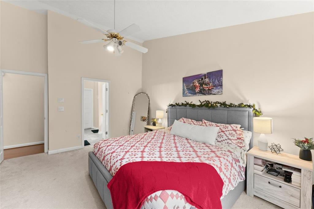 2980 Phillips Bend Crossing Northeast Buford, GA 30519 - Photo 17 of 45 a bedroom with a bed and a chandelier