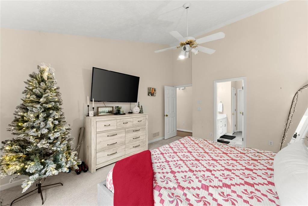 2980 Phillips Bend Crossing Northeast Buford, GA 30519 - Photo 18 of 45 a bedroom with a bed and a flat screen tv