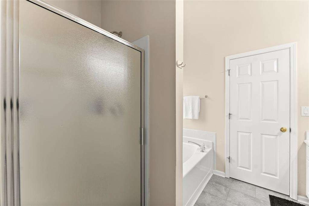 2980 Phillips Bend Crossing Northeast Buford, GA 30519 - Photo 21 of 45 a bathroom with a bathtub and a shower