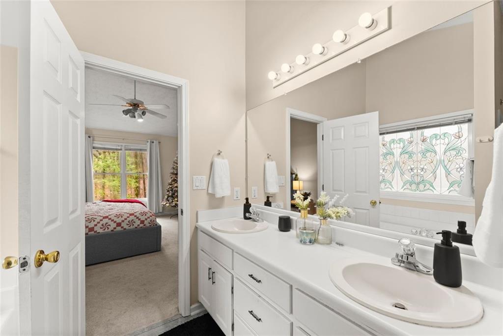 2980 Phillips Bend Crossing Northeast Buford, GA 30519 - Photo 22 of 45 a en suite bathroom with double vanity and a mirror