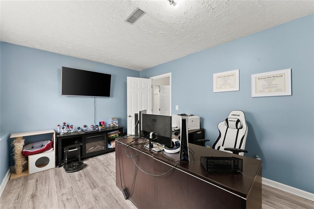 2980 Phillips Bend Crossing Northeast Buford, GA 30519 - Photo 23 of 45 a room with a couch and a flat screen tv