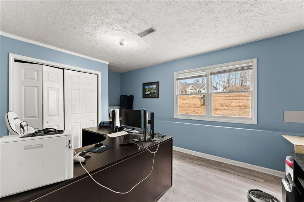 2980 Phillips Bend Crossing Northeast Buford, GA 30519 - Photo 24 of 45 a room with gym equipment and a window