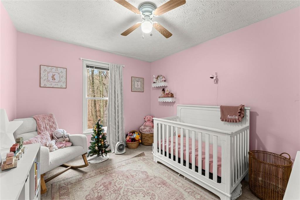 2980 Phillips Bend Crossing Northeast Buford, GA 30519 - Photo 28 of 45 a bedroom with furniture and a window