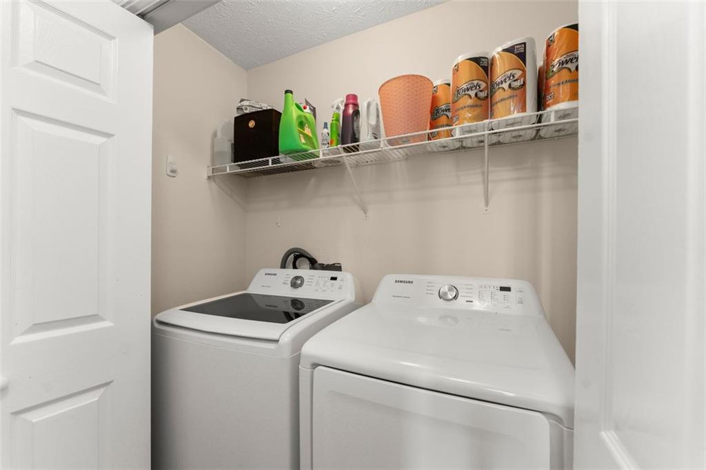 2980 Phillips Bend Crossing Northeast Buford, GA 30519 - Photo 31 of 45 a utility room with dryer and washer
