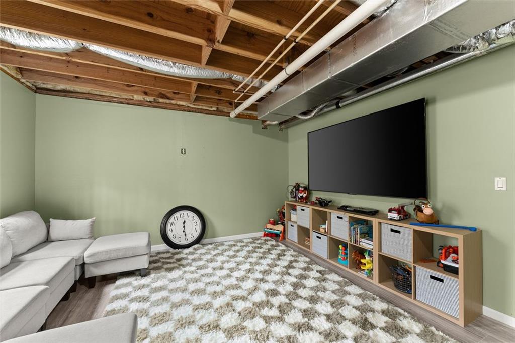 2980 Phillips Bend Crossing Northeast Buford, GA 30519 - Photo 33 of 45 a living room with furniture and a flat screen tv