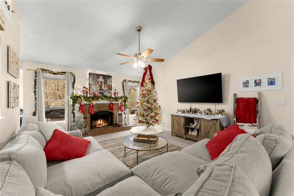 2980 Phillips Bend Crossing Northeast Buford, GA 30519 - Photo 5 of 45 a living room with furniture flat screen tv and a fireplace