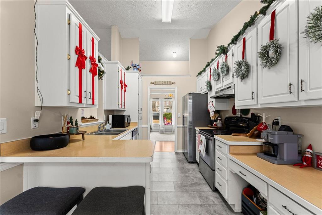 2980 Phillips Bend Crossing Northeast Buford, GA 30519 - Photo 8 of 45 a kitchen with a sink a stove and cabinets