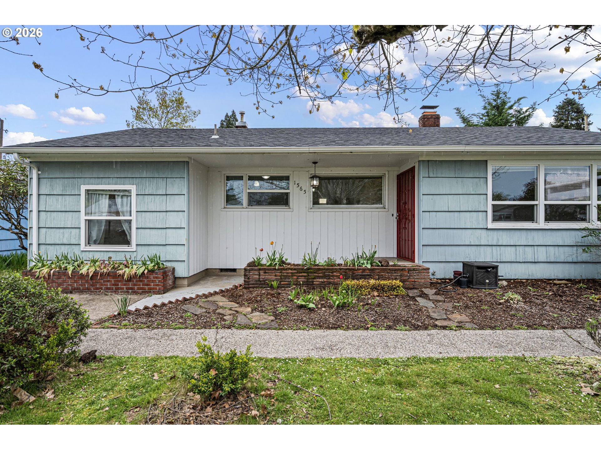 1565 Linwood Street Eugene, OR 97404 - Photo 1 of 42 a front view of a house with garden