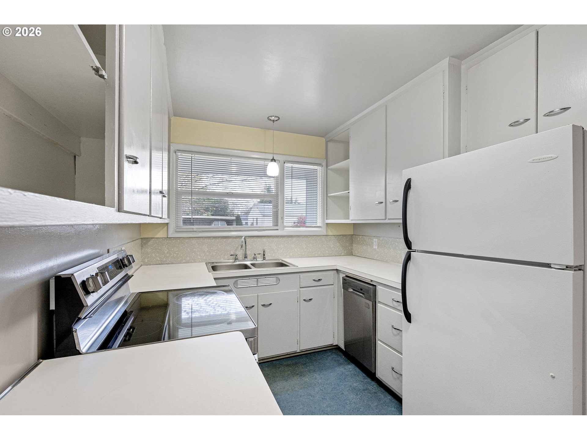 1565 Linwood Street Eugene, OR 97404 - Photo 11 of 42 a kitchen that has a sink a window and stainless steel appliances