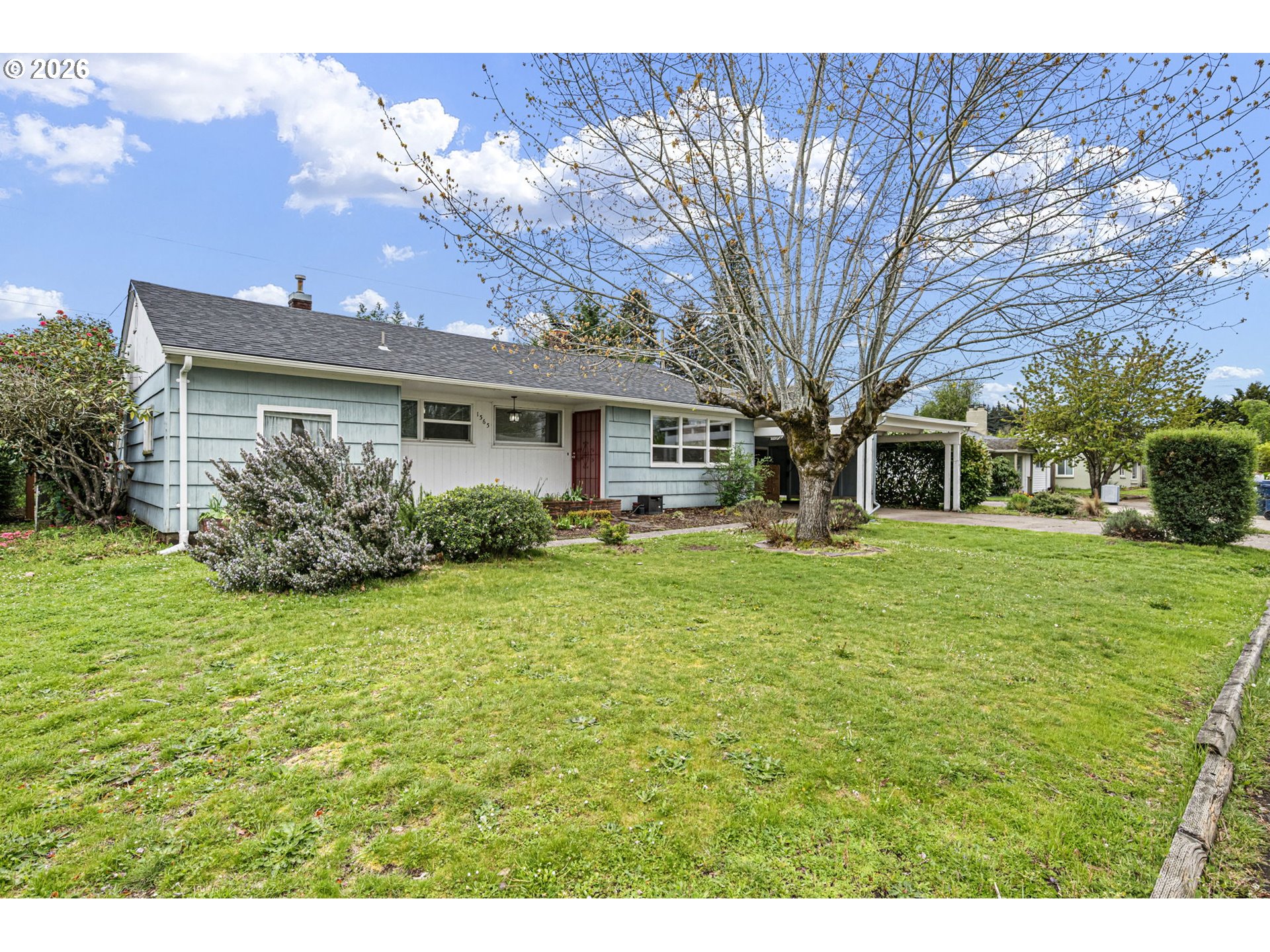 1565 Linwood Street Eugene, OR 97404 - Photo 2 of 42 a front view of a house with a garden