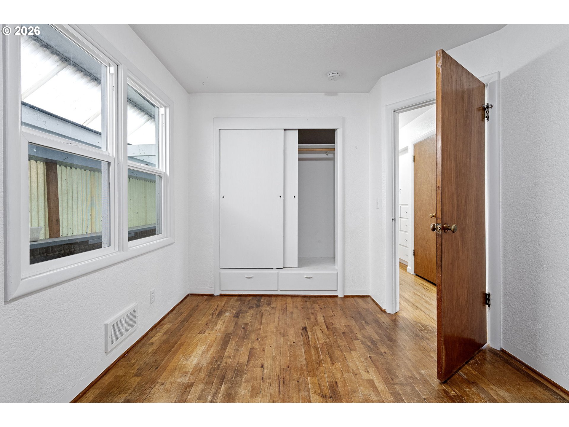 1565 Linwood Street Eugene, OR 97404 - Photo 21 of 42 a view of an empty room with wooden floor and a window