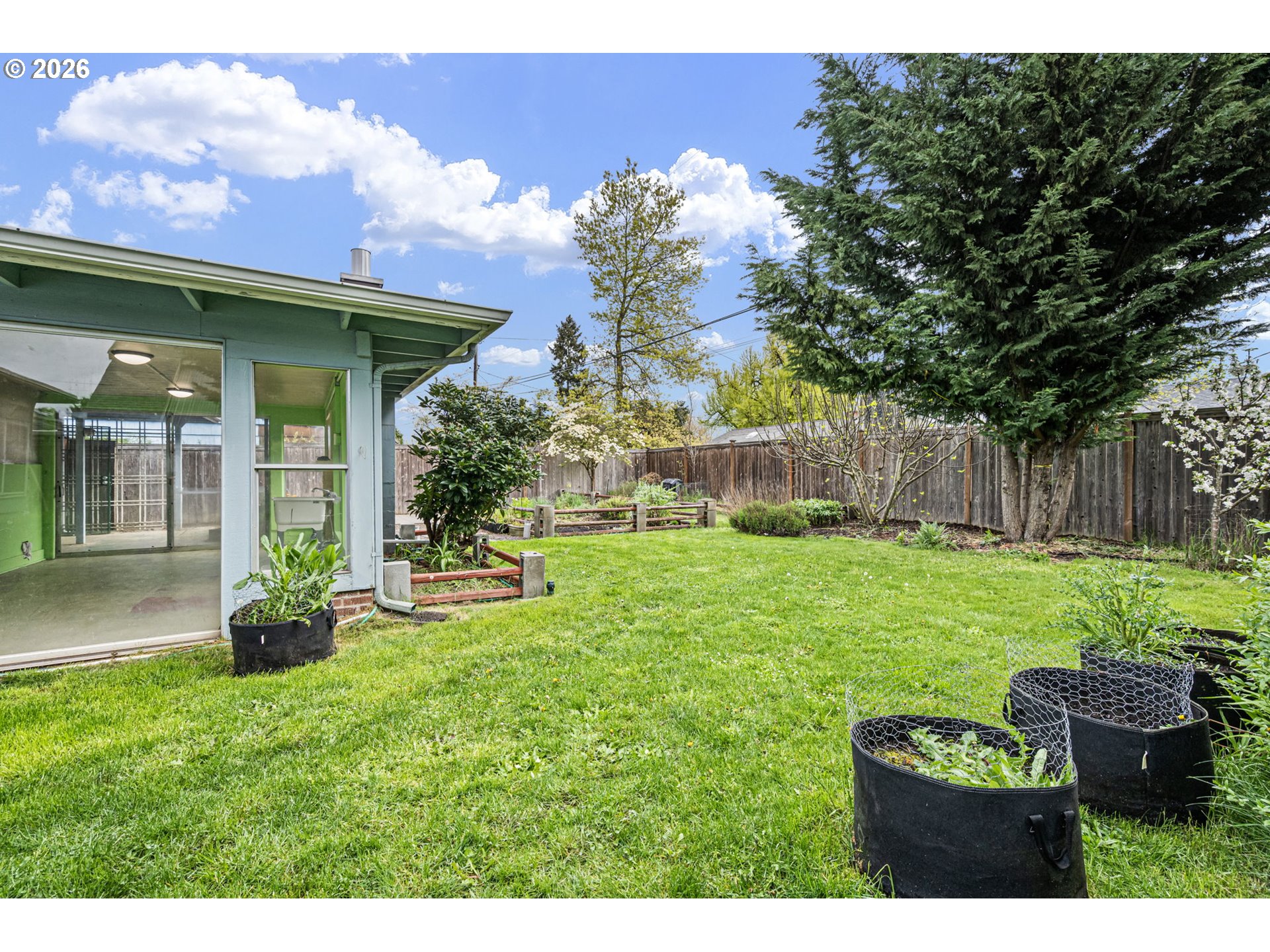 1565 Linwood Street Eugene, OR 97404 - Photo 35 of 42 a view of a backyard with table and chairs and potted plants