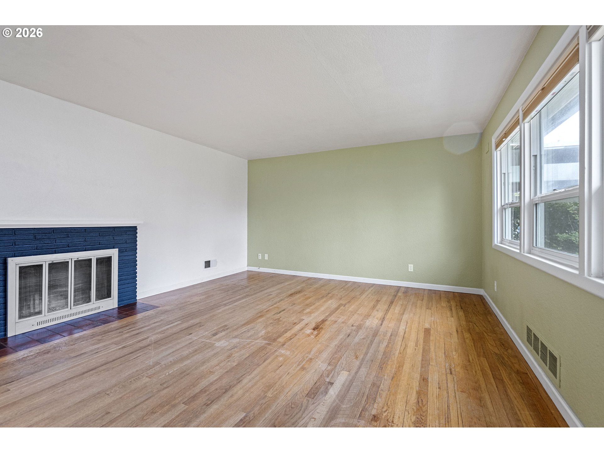 1565 Linwood Street Eugene, OR 97404 - Photo 6 of 42 a view of an empty room with wooden floor and a window