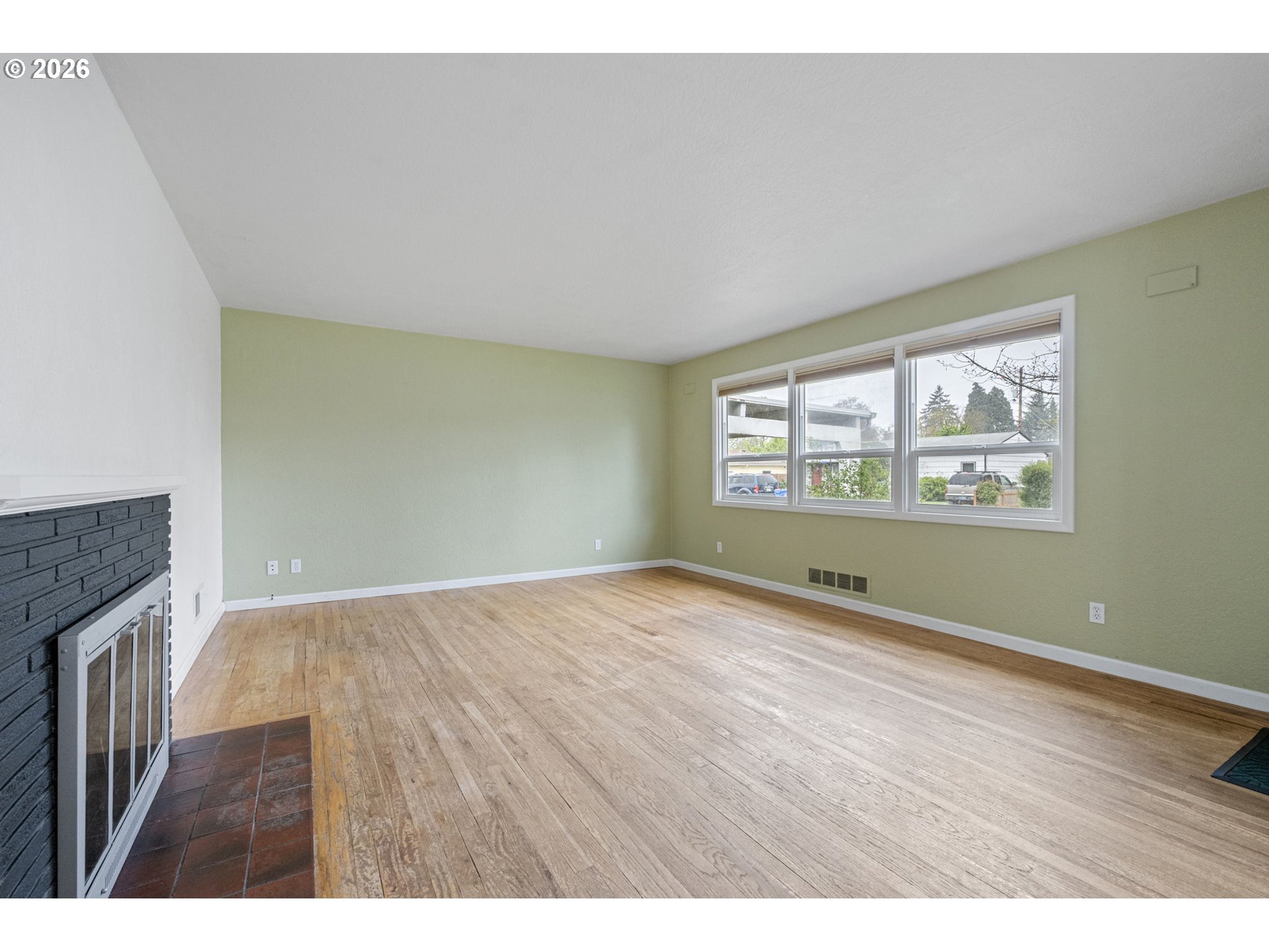 1565 Linwood Street Eugene, OR 97404 - Photo 7 of 42 a view of an empty room with a window and wooden floor
