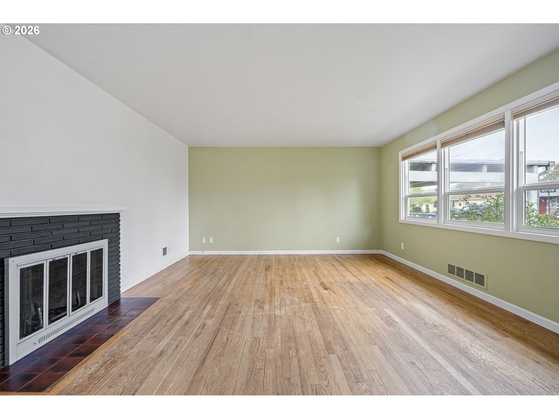 1565 Linwood Street Eugene, OR 97404 - Photo 8 of 42 a view of an empty room with wooden floor and a window