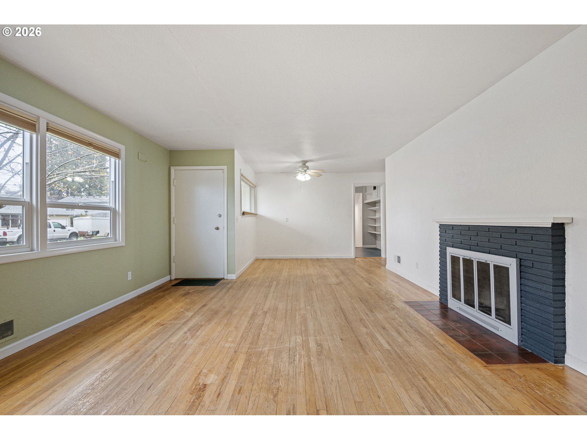1565 Linwood Street Eugene, OR 97404 - Photo 9 of 42 a view of an empty room with wooden floor and a window