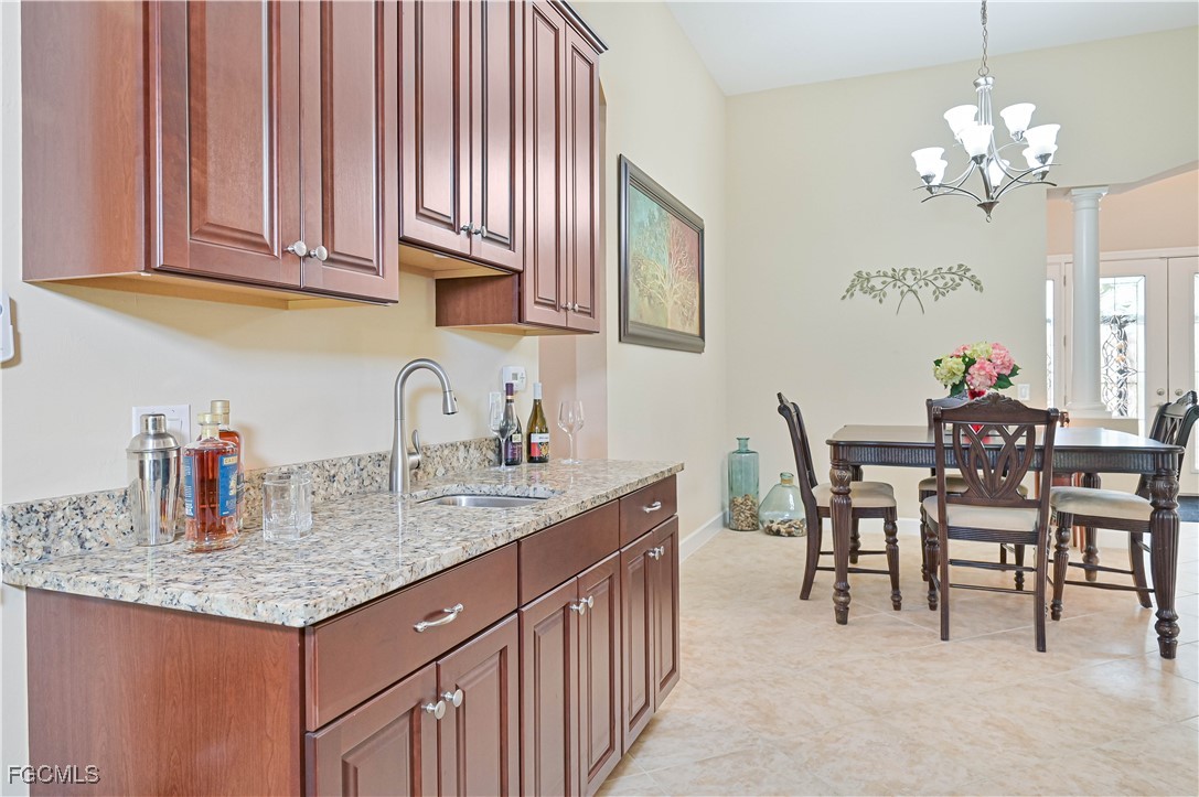 17283 Walnut Run Drive Alva, FL 33920 - Photo 15 of 49 a kitchen with sink cabinets and dining table