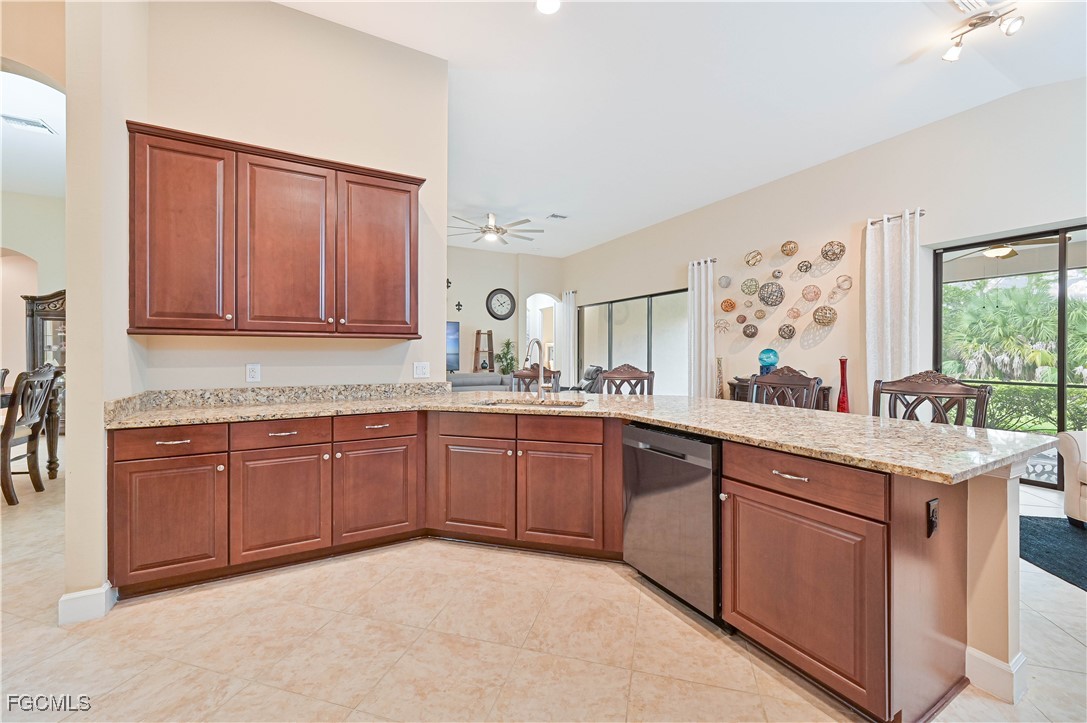 17283 Walnut Run Drive Alva, FL 33920 - Photo 21 of 49 a kitchen with stainless steel appliances granite countertop a sink dishwasher stove and wooden cabinets