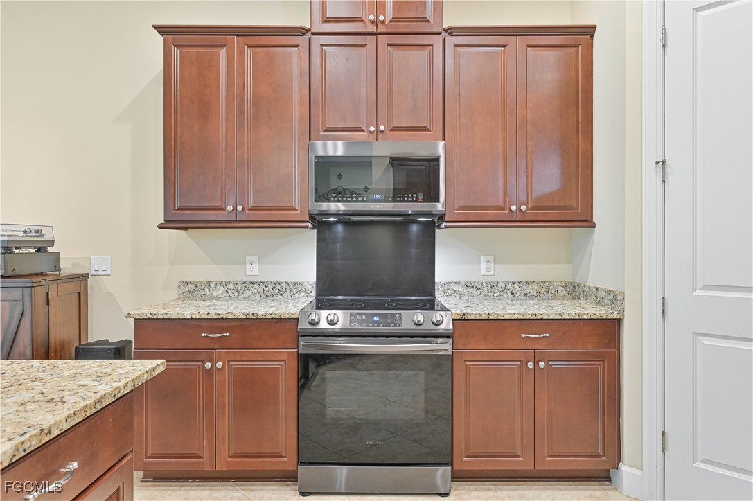 17283 Walnut Run Drive Alva, FL 33920 - Photo 22 of 49 a kitchen with granite countertop cabinets and steel stainless steel appliances