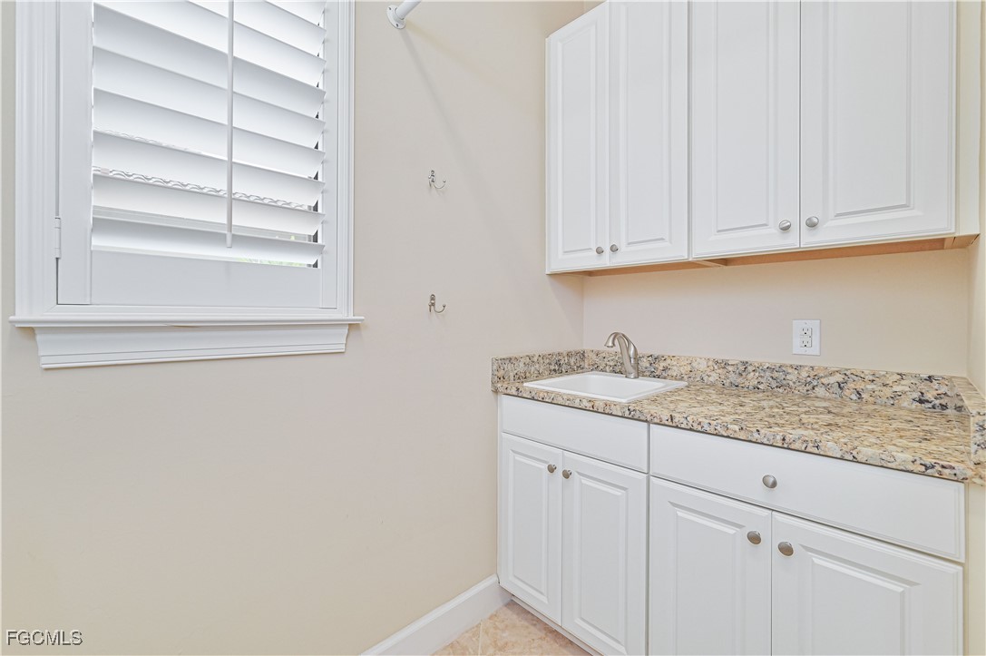 17283 Walnut Run Drive Alva, FL 33920 - Photo 26 of 49 a kitchen with granite countertop white cabinets and a sink