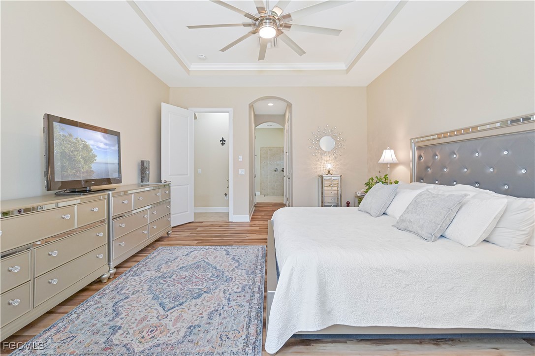 17283 Walnut Run Drive Alva, FL 33920 - Photo 29 of 49 a spacious bedroom with a bed and a flat screen tv