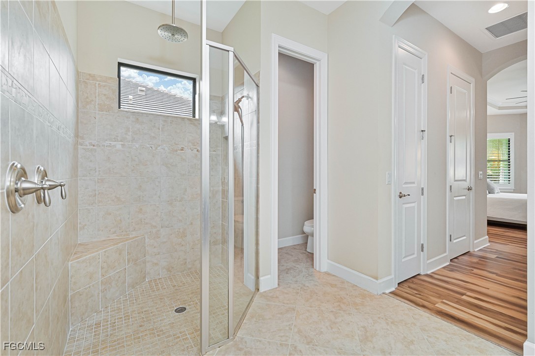 17283 Walnut Run Drive Alva, FL 33920 - Photo 32 of 49 a view of a hallway with wooden floor and a bathroom