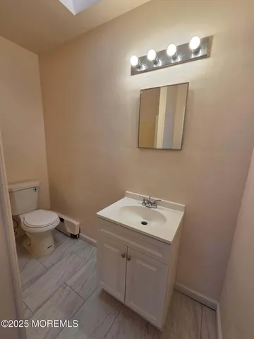 a bathroom with a sink a toilet and mirror