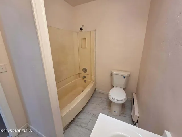 a bathroom with a toilet and a bathtub
