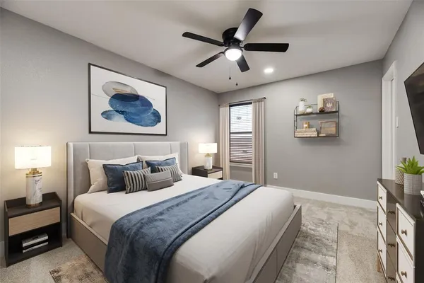 a bedroom with a large bed and a chandelier