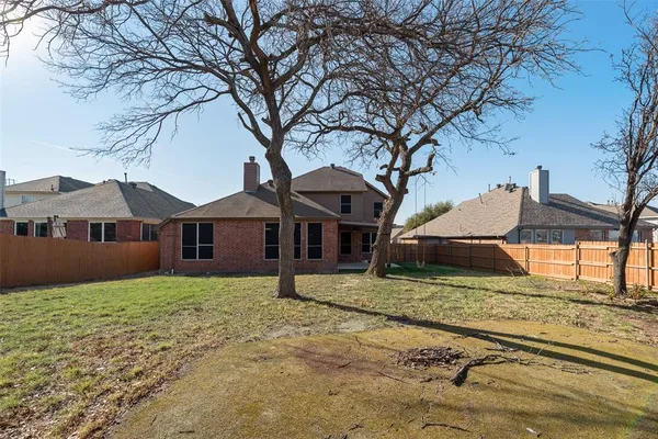 a house that has a tree in front of it