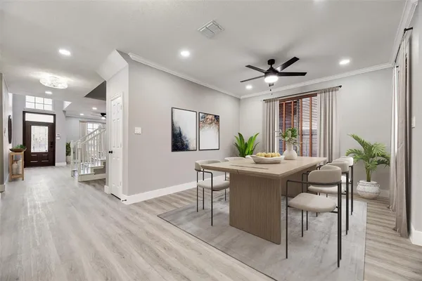 a view of a dining room with furniture window and wooden floor
