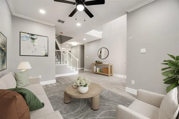 a living room with furniture and a wooden floor