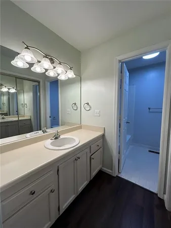 a spacious bathroom with a double vanity sink and a mirror