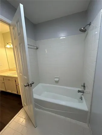 a spacious bathroom with a bathtub and a shower