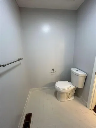 a white toilet sitting next to a white sink