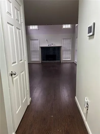 a view of a livingroom with wooden floor and a fireplace