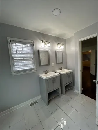 a bathroom with a sink a mirror and a bathtub