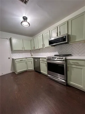 a kitchen with a stove and a microwave