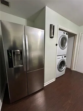 a view of a refrigerator in kitchen and a wooden floor