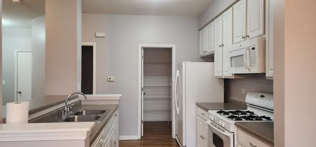 a view of a room with wooden floor and windows