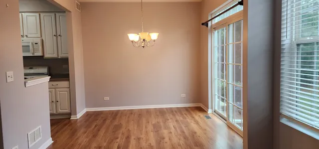 a kitchen with a refrigerator and a stove top oven