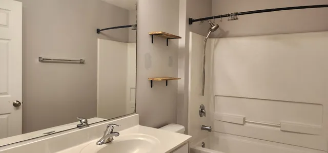 a view of an empty room with a window