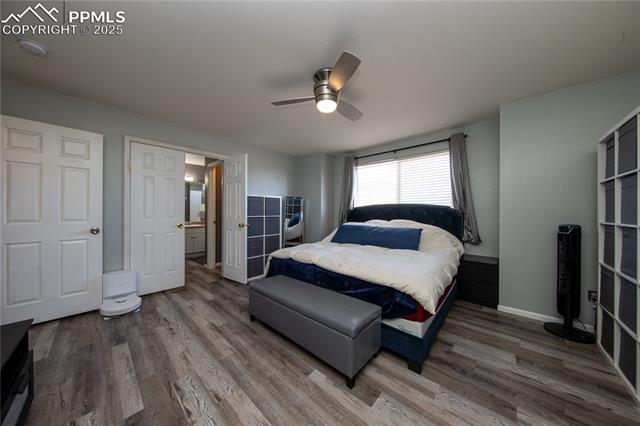 7511 Coffee Road Peyton, CO 80831 - Photo 24 of 38 Bedroom with wood finished floors, ceiling fan, and baseboards