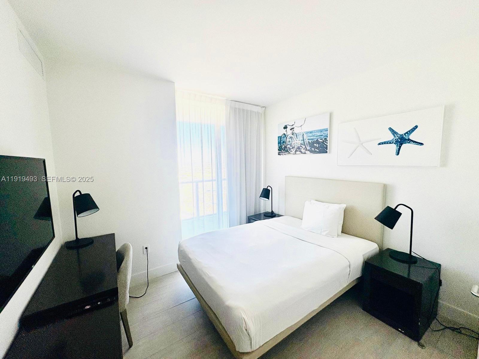 4010 South Ocean Drive, Unit R2904 Hollywood, FL 33019 - Photo 11 of 32 a bedroom with a bed and furniture